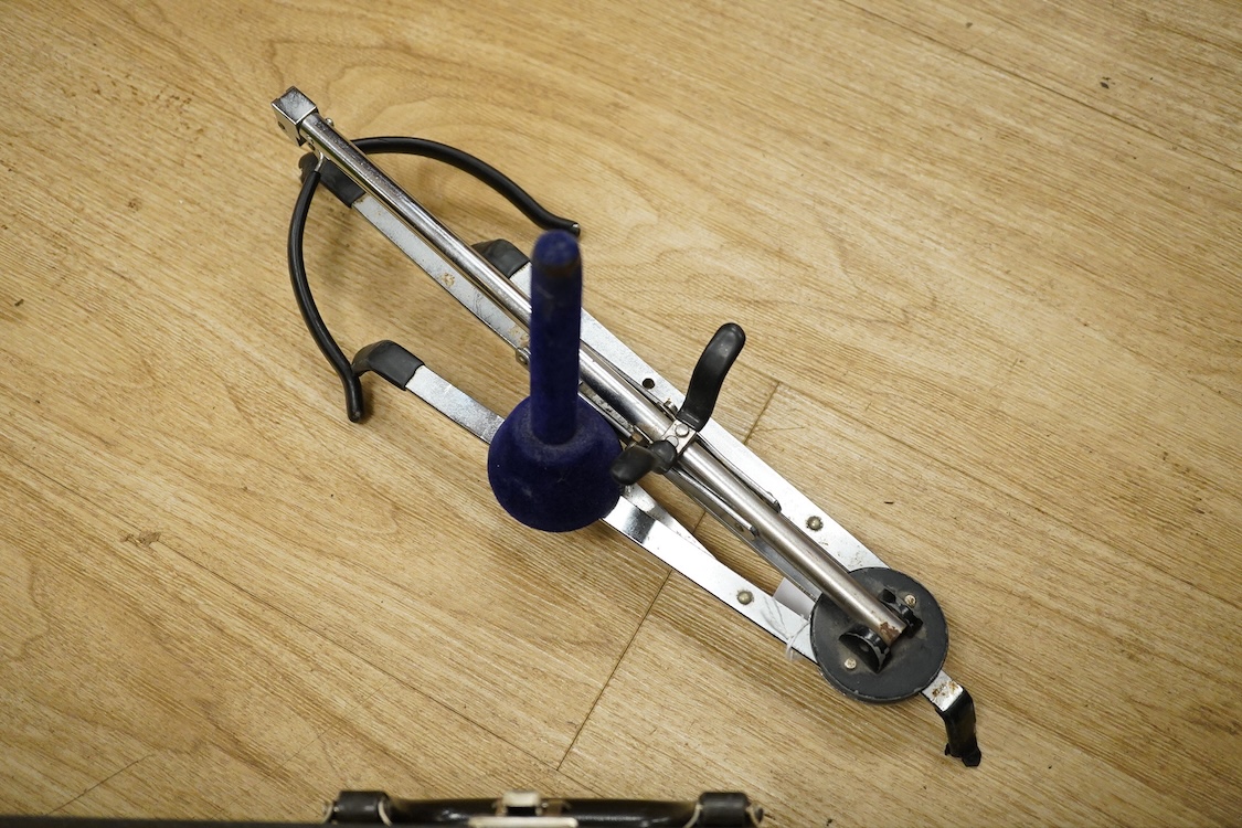 A cased Buescher Aristocrat tenor saxophone and stand